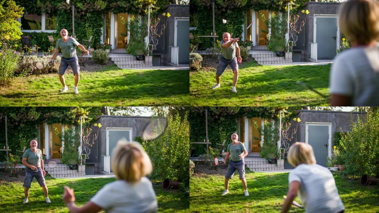 在花园里打羽毛球的高级夫妇