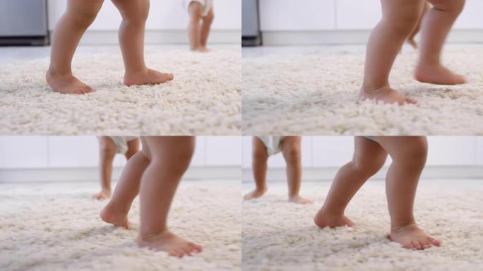 无法辨认的赤脚双胞胎幼儿的腿在蓬松的地毯上行走