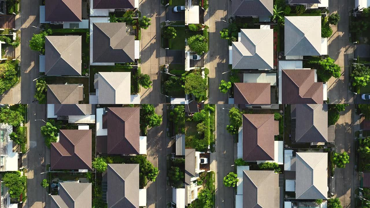 无人机在一个村庄的屋顶上飞行的录像带，早晨的阳光为居住，城市社会或繁荣的城市社区的概念增添了维度。