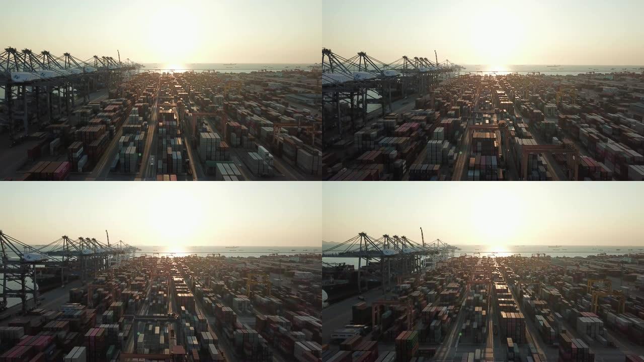 日落时港口货物集装箱的鸟瞰图