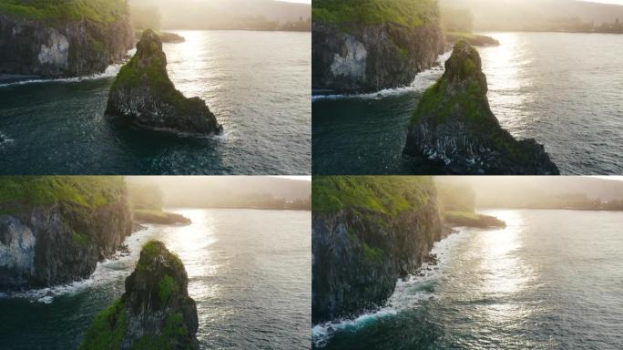 日落时海洋中的惊人岩石顶峰