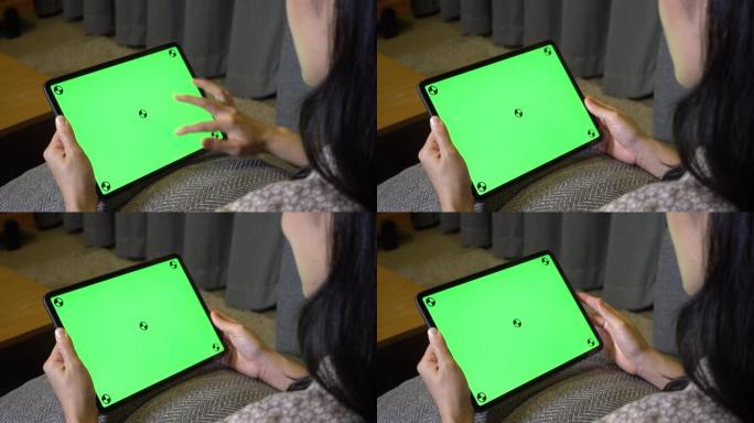 女人使用绿色屏幕数字平板电脑，水平