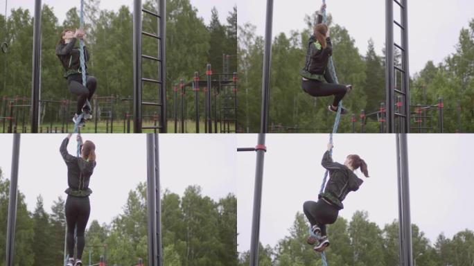 女运动员在公园的户外健身房攀岩绳