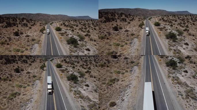 在美国亚利桑那州炎热的夏天，无人机在沿着美丽的砂岩沙漠山路行驶的大型送货卡车上倾斜。