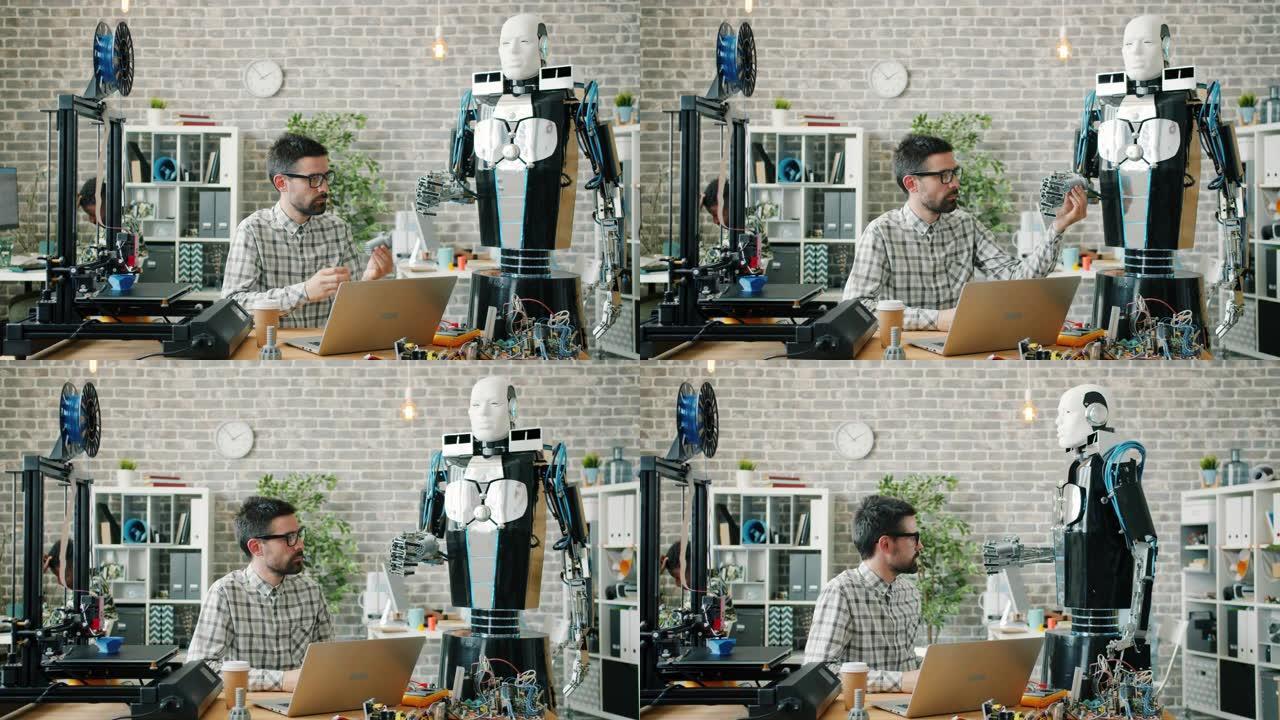 年轻的开发人员将3d打印模型提供给办公室的智能机器人测试机