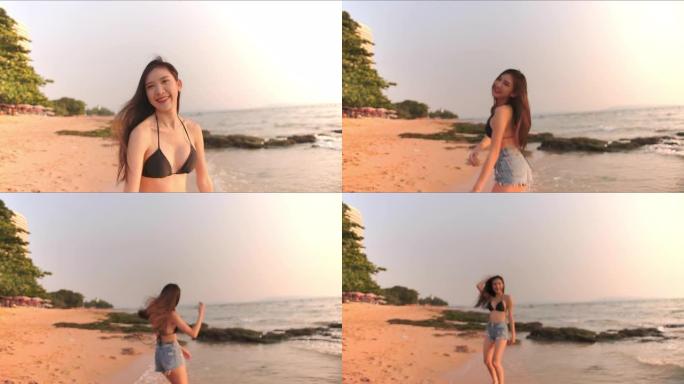 4k分辨率迷人的亚洲女性在海滩上，美丽的女性快乐放松跑步和娱乐，生活方式女性在海滩上旅行的概念。