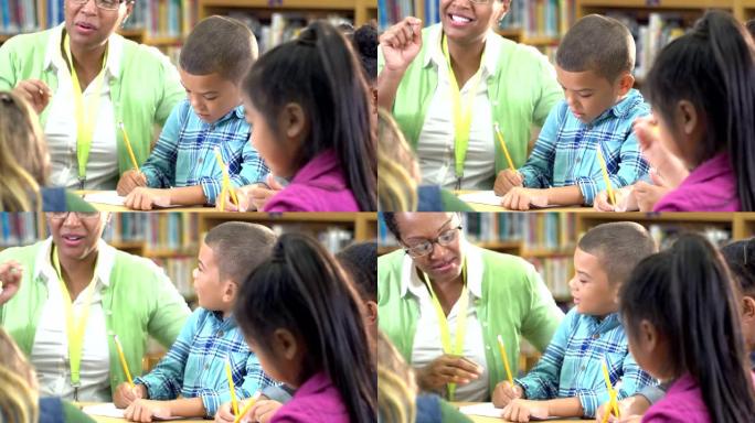混血男孩，老师，同学在图书馆写作
