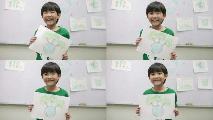 穿着绿色生态t恤的小男孩肖像，拿着他关于拯救世界项目的图纸。志愿者、自然和教育理念。