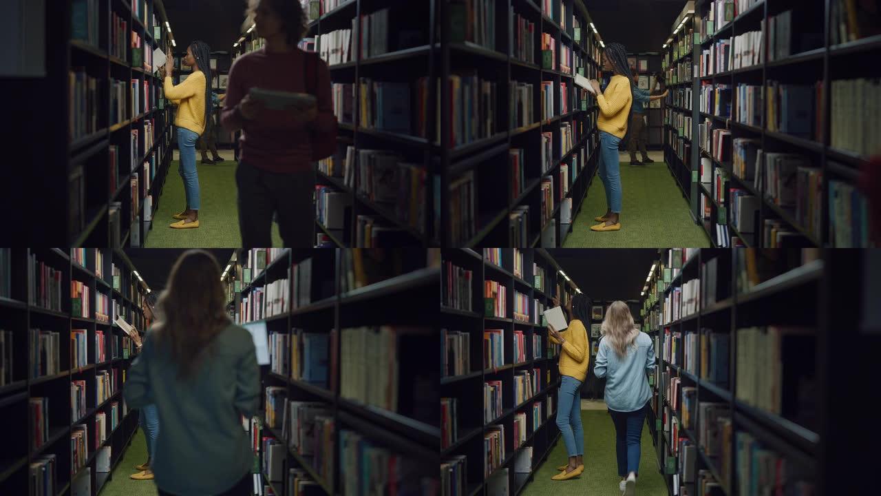 大学图书馆:不同的学生群行走在一排排书架之间，寻找合适的课本，为课堂作业和考试准备。真正的人学习，学