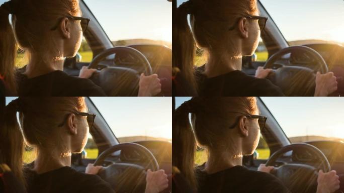 女人开车进入日落女人开车手握方向盘