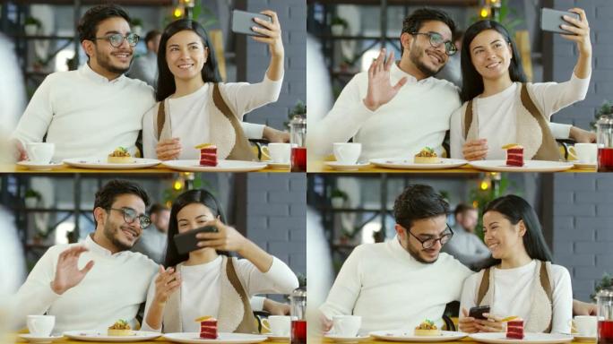 微笑的情侣在咖啡馆用智能手机自拍