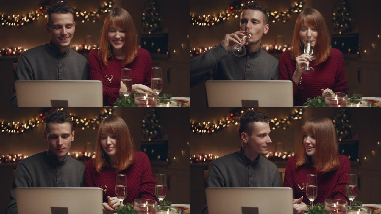 年轻夫妇在网上遇见圣诞节。他们通过互联网与亲戚交流。