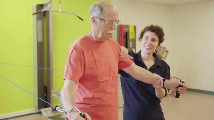 物理治疗师帮助高年级男子滑轮