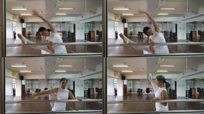 一名亚洲华裔女芭蕾舞演员在舞蹈工作室练习并做好准备