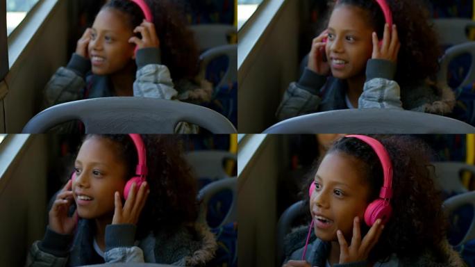 女孩在4k公共汽车上旅行时戴着耳机听音乐