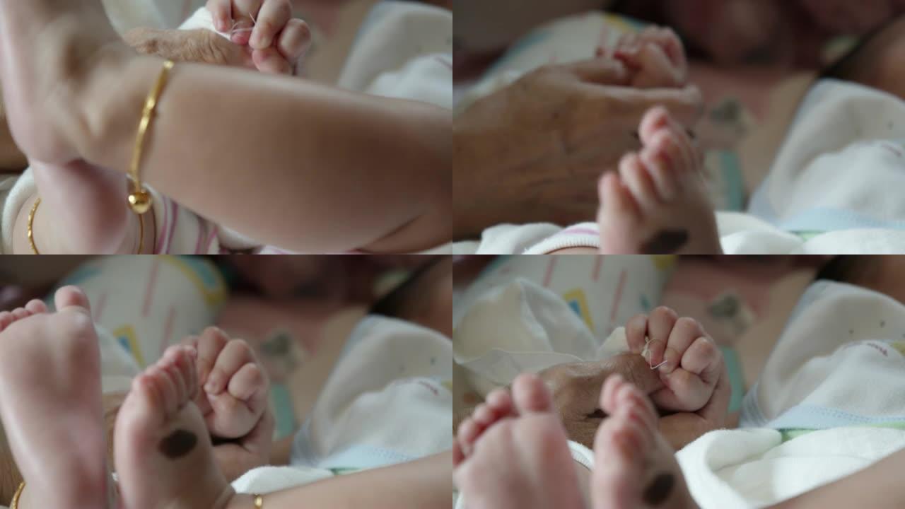 婴儿握着祖母的手。感到拯救和快乐