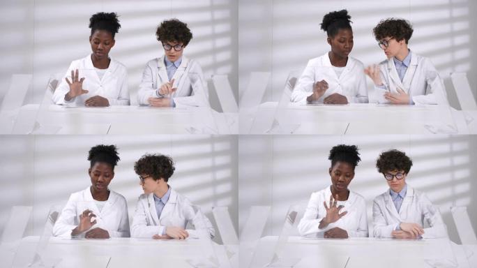 两名女性科学家在实验室中一起研究未来派触摸屏