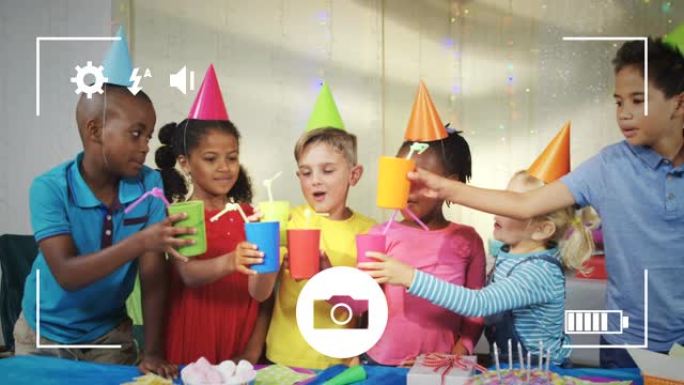 在数码相机上的生日聚会上给孩子们拍照