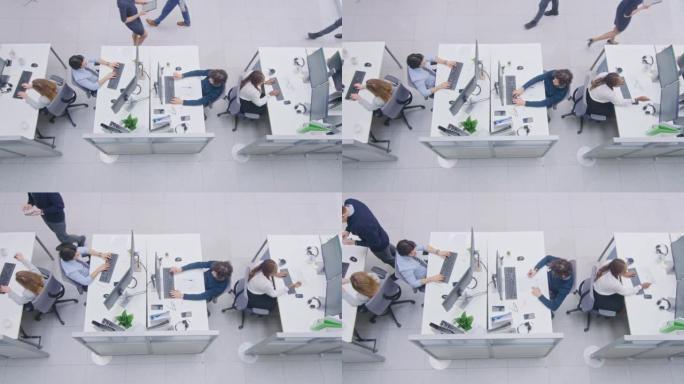 在忙碌的办公室中，各行各业的专业人员在台式计算机上工作，交谈，做客户支持，与客户沟通，监控统计数据，