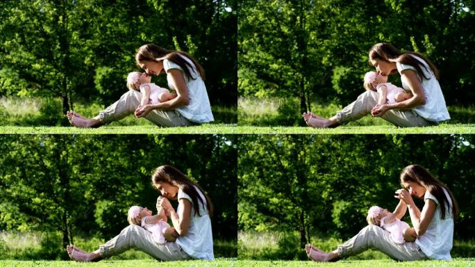 在一个美丽而快乐的阳光明媚的日子里，一个母亲和婴儿小女孩玩耍，快乐地沉浸在五彩缤纷的大自然和幸福中，
