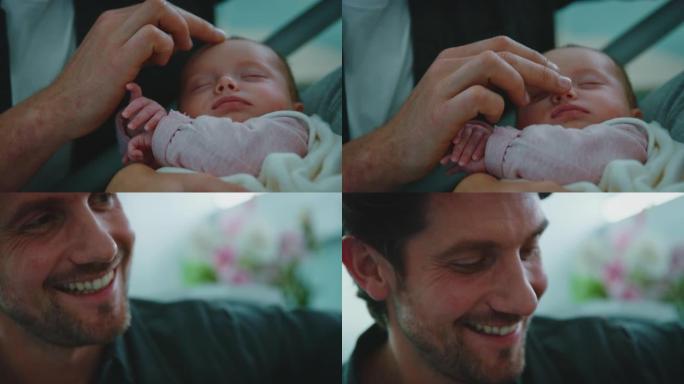 快乐的父亲抚摸着医院里的婴儿的脸