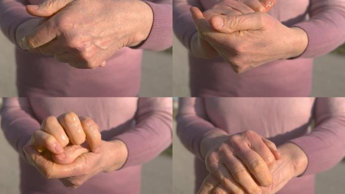 特写: 白人妇女在双手之间摩擦抗菌消毒凝胶。