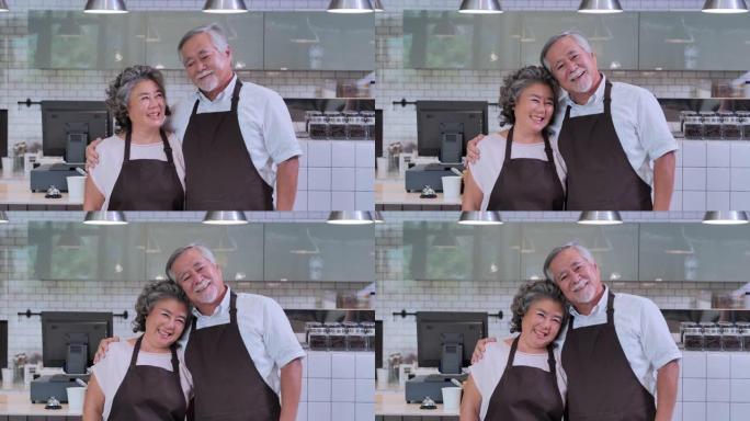 咖啡馆里快乐的亚洲老年夫妇在镜头前微笑的肖像。创业，愿景，创新，机遇，小企业，老龄化，智慧，独立，协