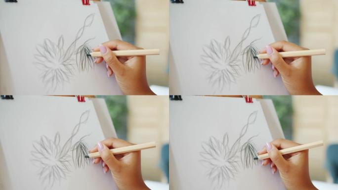 女性手工画花在纸上的特写，创造美丽的图画