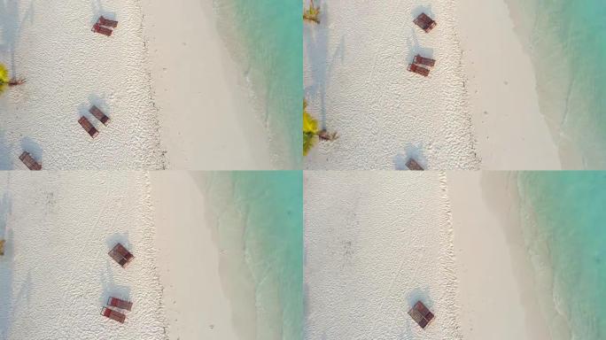 马尔代夫宁静热带海滩躺椅上方的女士景观