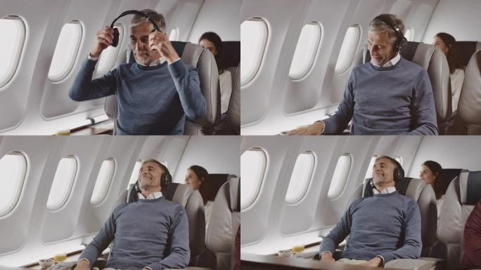 在私人飞机上戴着耳机的商人