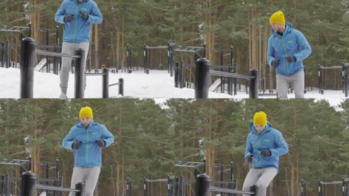 穿着蓝色风衣的健身男子冬季户外耐力运动