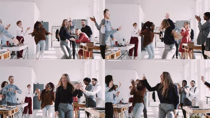 红色史诗-W 8К 两个快乐的多元化商业女性在办公室团队庆祝派对慢动作上做有趣的赢家舞蹈。