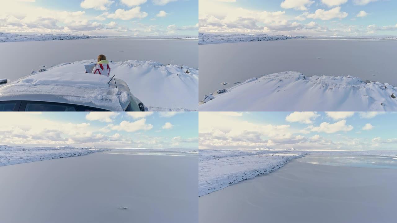 WS女人，地图站在车外，俯瞰冰岛白雪皑皑的风景和海景