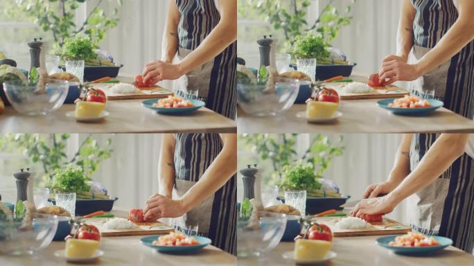 一个男人用锋利的菜刀切碎西红柿的特写镜头。在现代厨房准备健康的有机沙拉餐。天然清洁饮食和健康的生活理