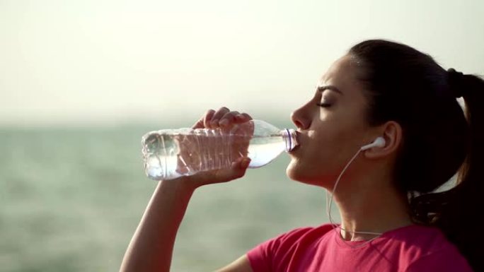 口渴的女运动员正在喝水