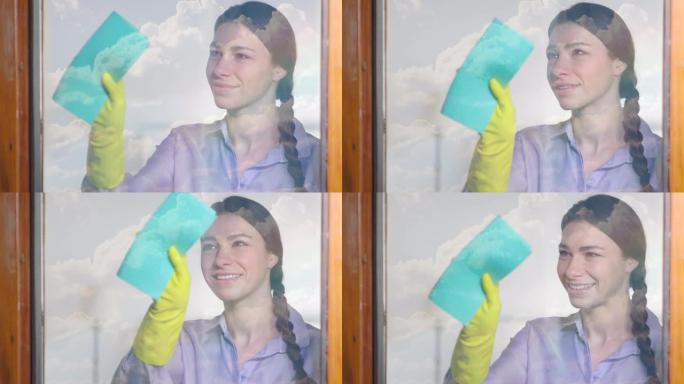 一个努力打扫房子的美丽女人故意用喷雾剂和布清洗玻璃。