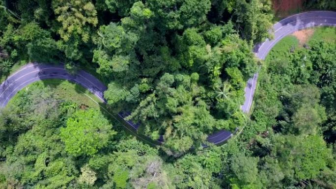 顶视图森林和山脉中的路，穿越泰国森林的公路旅行