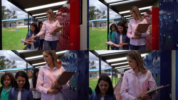 女学生看着老师在书上的笔记和走在他们后面的同学时非常高兴地与老师交谈