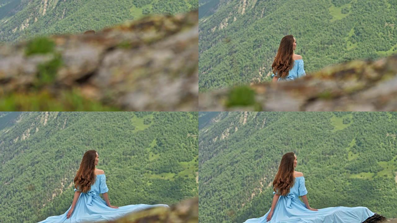 穿着优雅礼服的女人在山里摆姿势。山地景观