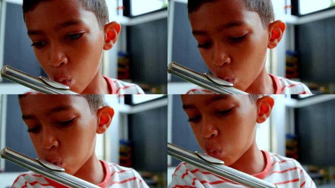 4k学校教室里细心的亚洲男生长笛的前视图