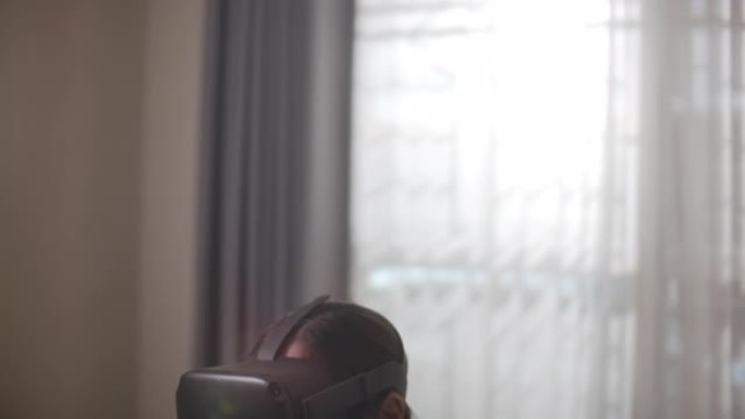 亚洲妇女使用VR眼镜玩拳击游戏在家锻炼