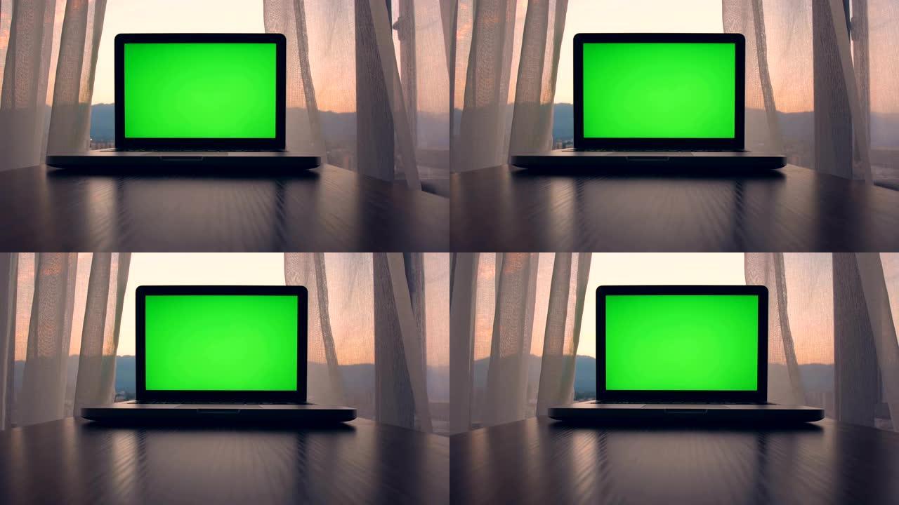 桌子上的绿色屏幕笔记本电脑屏幕