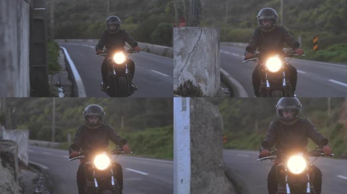 骑自行车的人在乡村公路上骑着经典摩托车