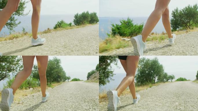 沿着大海奔跑的女跑步者的SLO MO腿