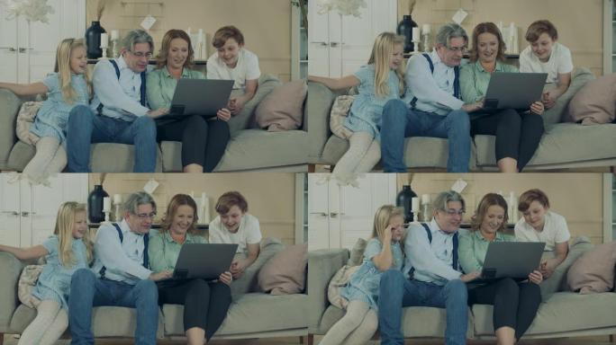 祖父母正在与孙子一起浏览笔记本电脑
