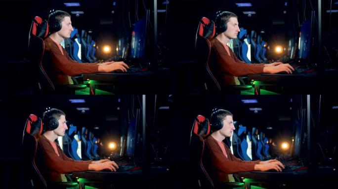 一个男人在俱乐部玩电子游戏的侧视图