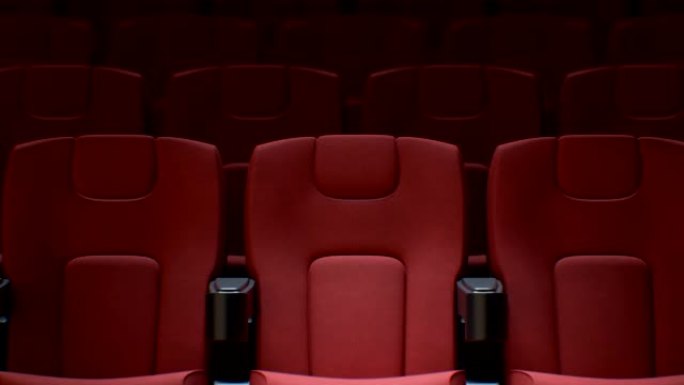 电影院大厅红色椅子上的电影院屏幕上闪烁的光线无缝。电影院一排排红色座位的循环3d动画。艺术和媒体概念