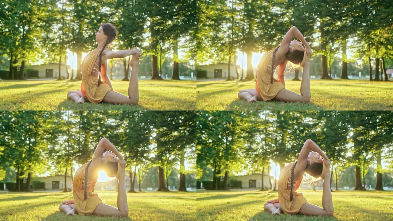 优雅，灵活的年轻女子在阳光明媚的公园练习瑜伽
