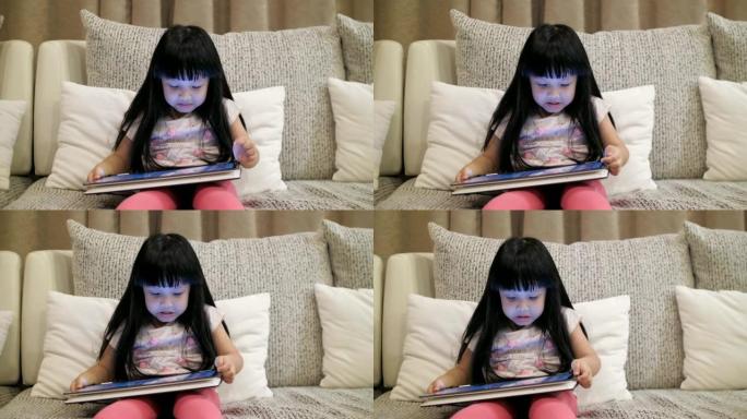慢动作: 小女孩晚上在平板电脑上观看娱乐媒体