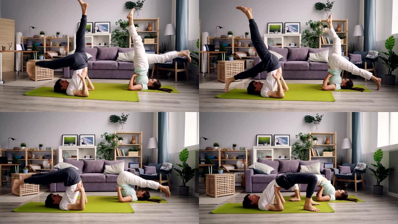 运动情侣在家锻炼，一起练习瑜伽，练习倒置体式